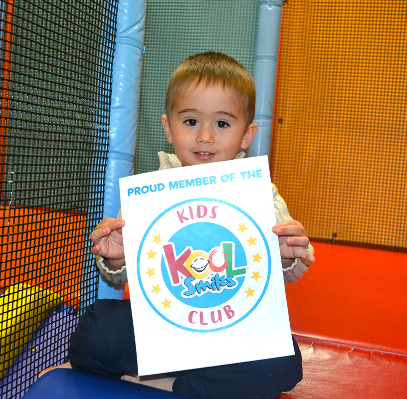 little boy holding activity book and playing